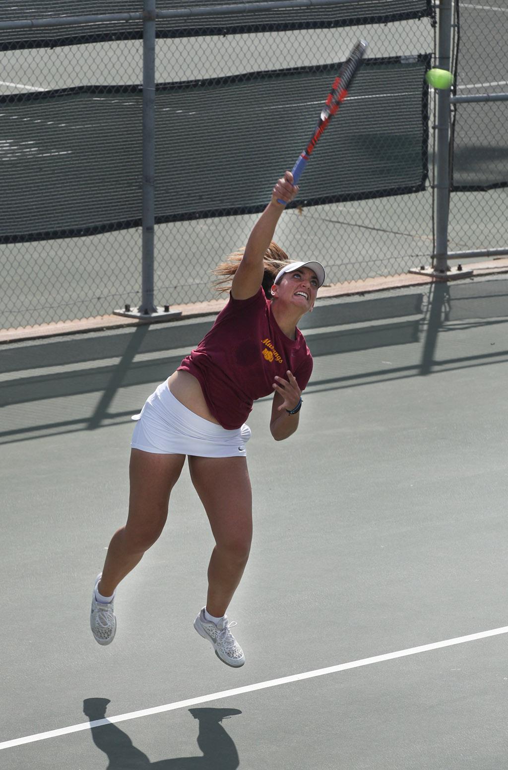 Eirini Kontaki, exercise physiology sophomore, serves the ball to the other side during a doubles game against Metro State at the MSU Tennis Center. Photo by Rachel Johnson