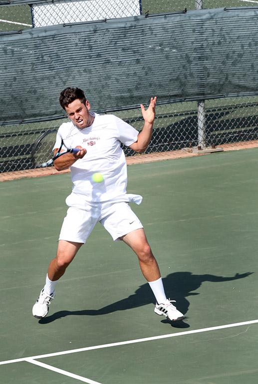Chris Norrie, general business senior, returns the ball to the other side during a doubles game against Metro State at the MSU Tennis Center. Photo by Rachel Johnson