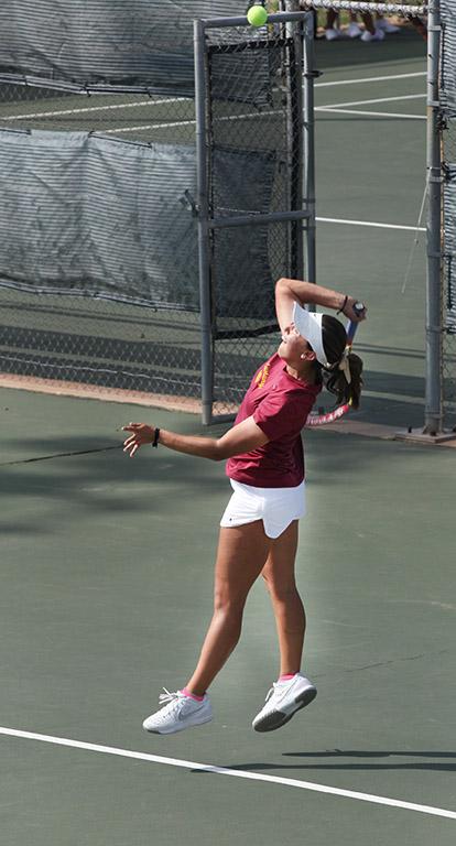 Ashley Ramirez, marketing freshman, serves the ball to the other side during a doubles game against Metro State at the MSU Tennis Center. Photo by Rachel Johnson