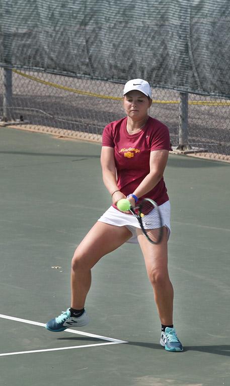 Bianca Duff, psychology freshman, returns the ball to the other side during a doubles game against Metro State at the MSU Tennis Center. Photo by Rachel Johnson