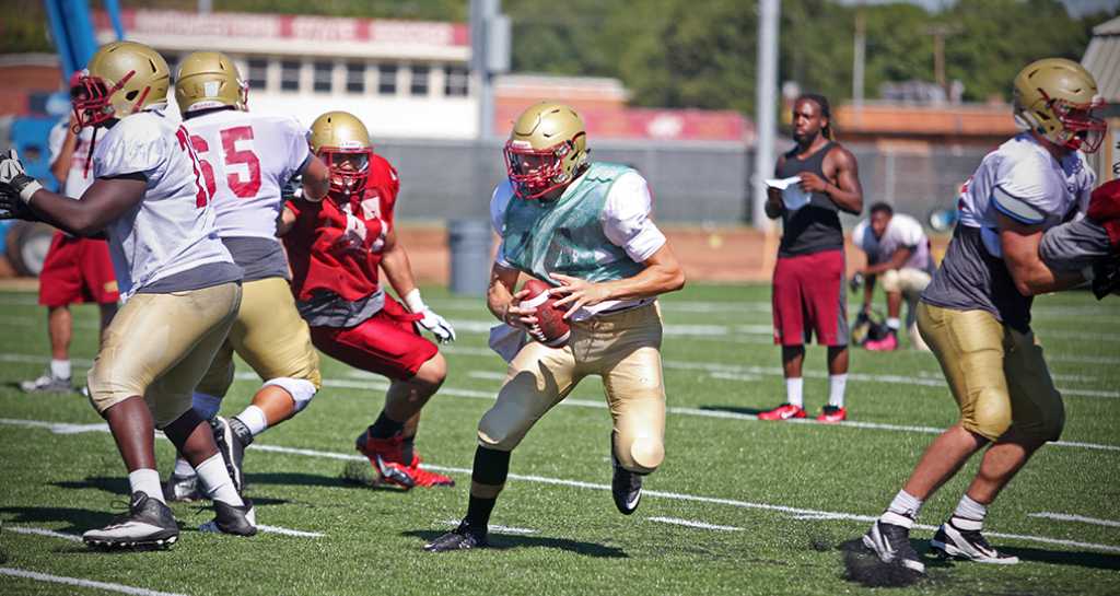 Quade Coward, quarterback, runs with the the ball during practice Aug. 16. Photo by Bradley Wilson.