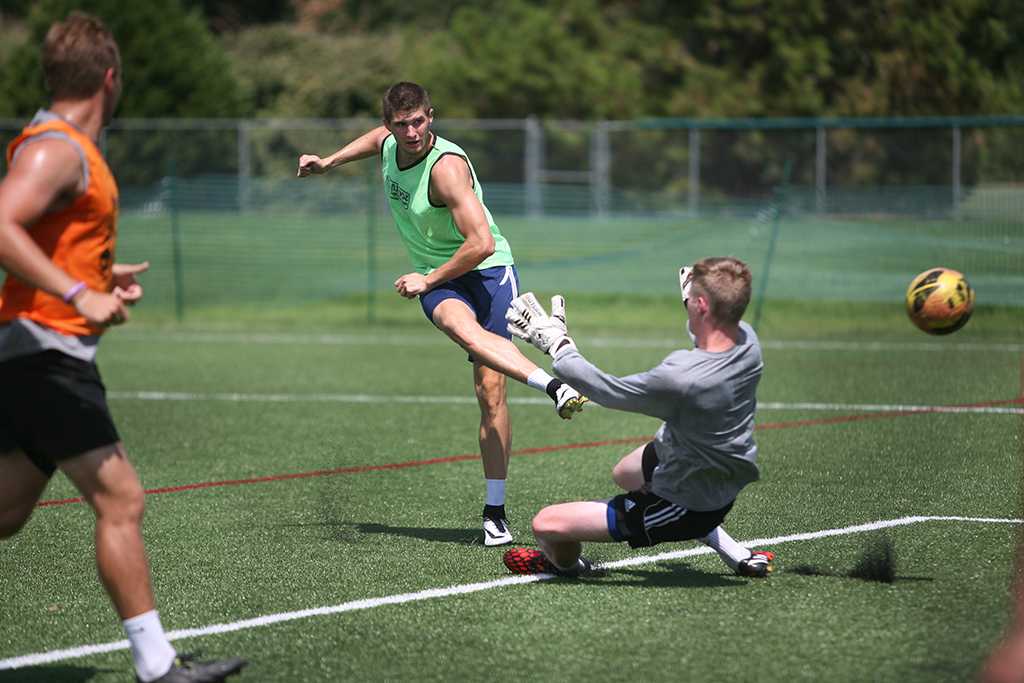 Aleksa Blagojevic, a junior in business, kicks the ball when the soccer players gathered the week before official practice began to run plays on the new turf field. Earlier in the week, coaches had recorded temperatures approaching 150ËF on the turf field. Photo by Bradley Wilson.