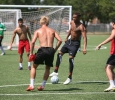Leon Taylor, business senior, fights for the ball when the soccer players gathered the week before official practice began to run plays on the new turf field. Earlier in the week, coaches had recorded temperatures approaching 150ËF on the turf field. Photo by Dylan Pembroke.