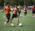 Jeffrey Palomarez, sophomore, and Kristian Martinez, computer science sophomore, fight for the ball when the soccer players gathered the week before official practice began to run plays on the new turf field. Earlier in the week, coaches had recorded temperatures approaching 150ËF on the turf field. Photo by Dylan Pembroke.