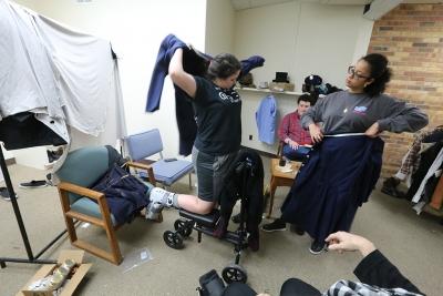 Kaylor Winter-Roach works with cast members and their costumes in preparation for "Urinetown" that opens Feb. 22 at Midwestern State University. Photo by Bradley Wilson