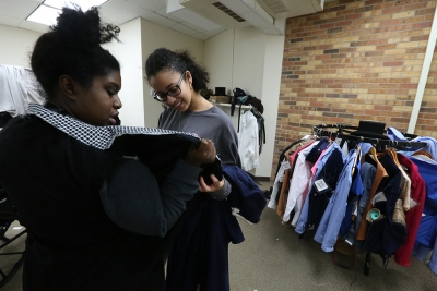 Kaylor Winter-Roach works with cast members and their costumes in preparation for "Urinetown" that opens Feb. 22 at Midwestern State University. Photo by Bradley Wilson