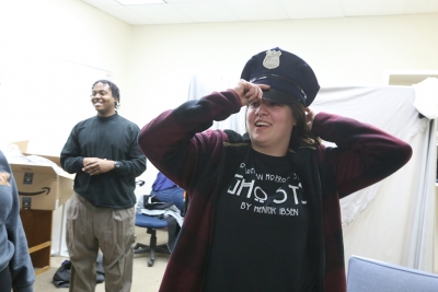 Ellanor Collins tries on her police officer's hat in preparation for "Urinetown" that opens Feb. 22 at Midwestern State University. Photo by Bradley Wilson