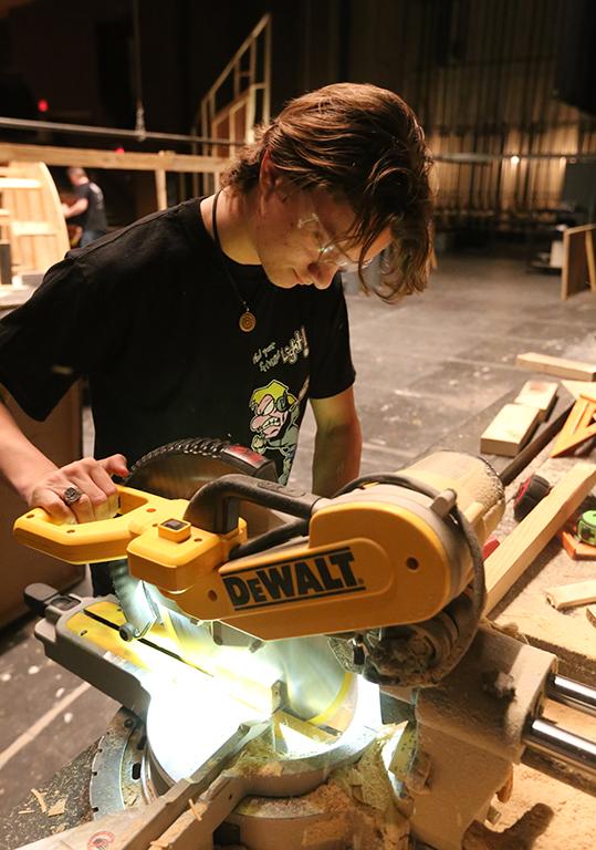 Ron Harle does woodwork for a pices of the "Urinetown" set Jan. 26. Photo by Bradley Wilson