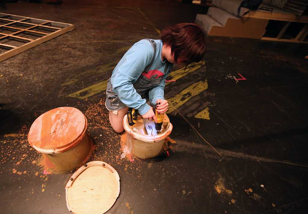 Shae Dorsman helps to take down the set of "Urinetown." Photo by Bradley Wilson