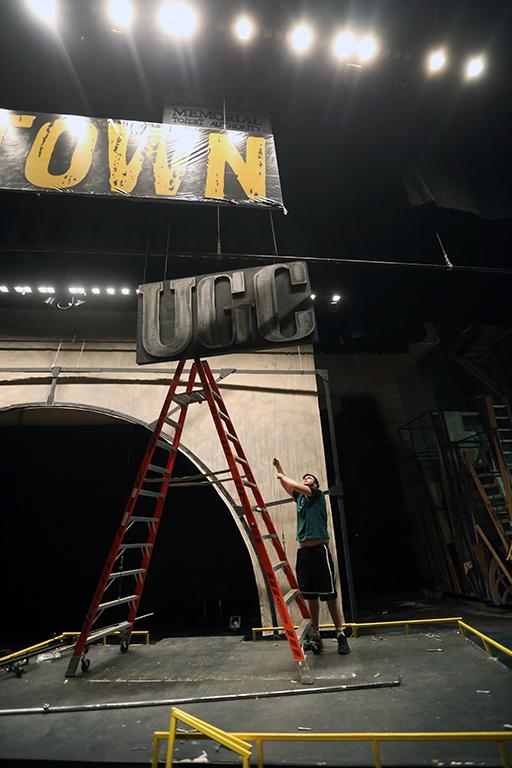 Joey McGinn helps to take down the set of "Urinetown." Photo by Bradley Wilson