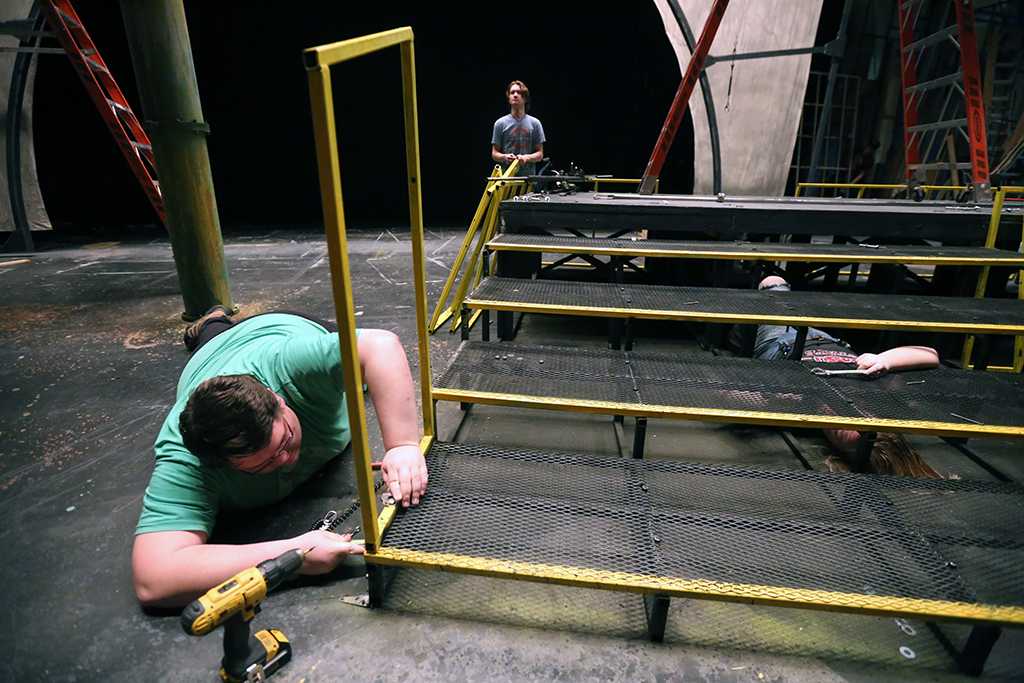 Dean Hart helps to take down the set of "Urinetown." Photo by Bradley Wilson