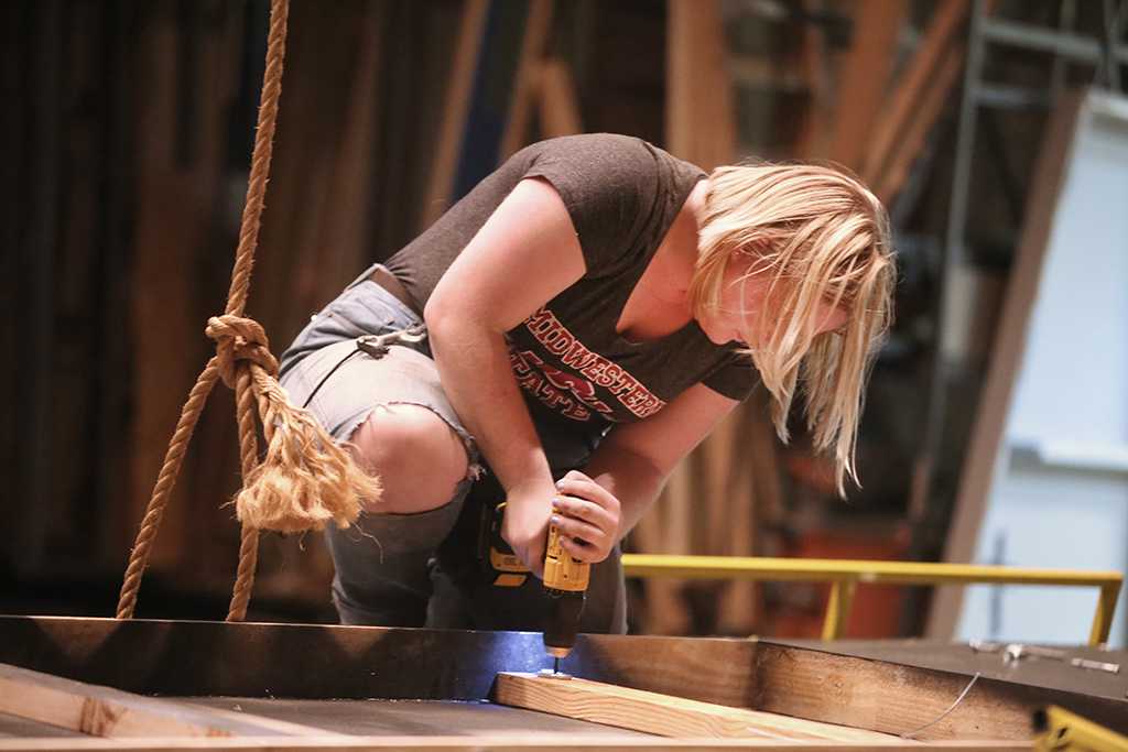 Emily Burns helps to take down the set of "Urinetown." Photo by Bradley Wilson