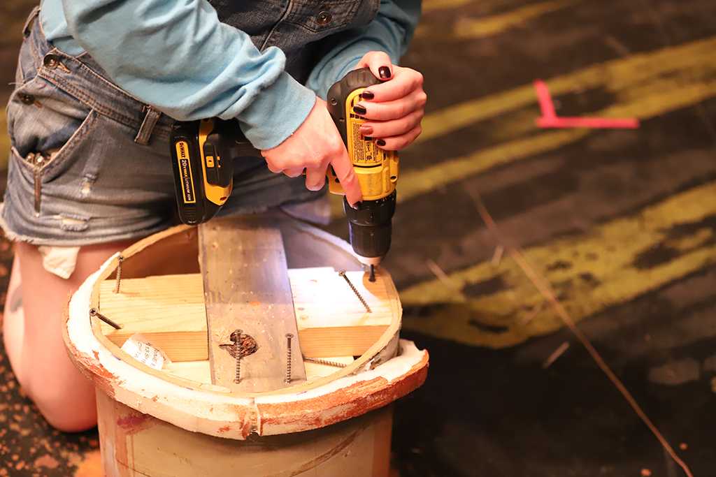 Shae Dorsman, theater junior, removes a "mushroom," as it was called by Dorsman, while striking the Urinetown set on Monday, March 5, 2018. Photo by Jeromy Stacy