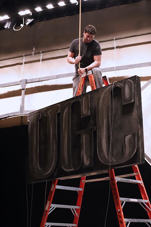 As part of strike, Ben Ashton directs the UGC sign as other crew lower it from above on Monday, March 5, 2018. Photo by Jeromy Stacy