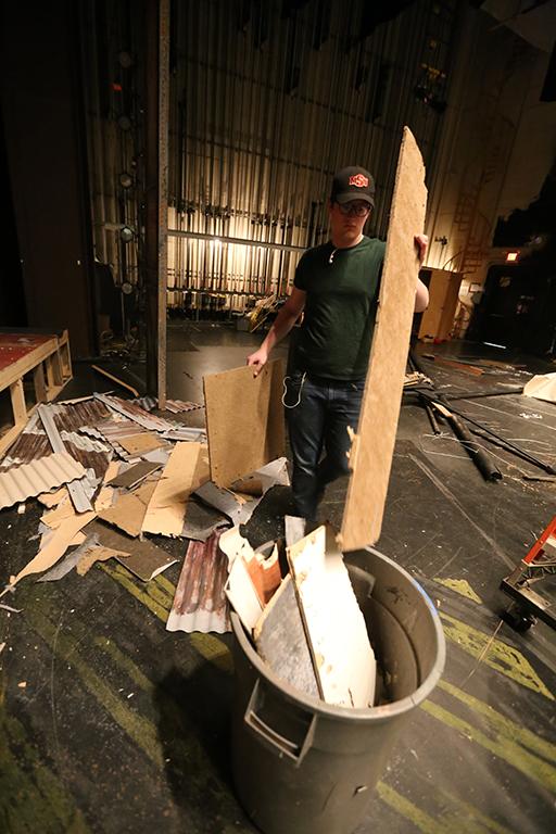 Seth Angelino helps to down the set of "Urinetown." Photo by Bradley Wilson