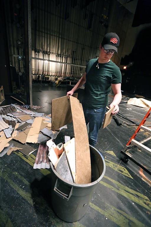 Seth Angelino helps to down the set of "Urinetown." Photo by Bradley Wilson