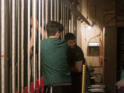 Joey McGinn, master carpentor theater junior, and Ben Ashton, blank blank, work to left the stage curtains at strike Monday March 5, 2018. Photo by Craig Tidmore
