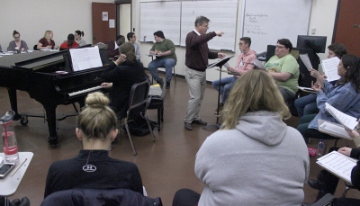Dale Heidebrecht, assistant music professor, leads the cast of UrineTown in their first rehearsal, Tuesday Dec. 5, 2017. Photo by Francisco Martinez