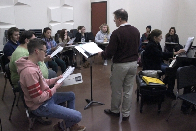 Dale Heidebrecht, assistant music professor, leads the cast of UrineTown in their first rehearsal, Tuesday Dec. 5, 2017. Photo by Francisco Martinez