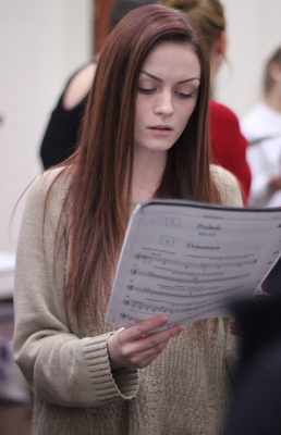 Kalli Root, English junior, practices one of the songs as one of the sopranos during the first rehearsal of UrineTown. Photo by Rachel Johnson