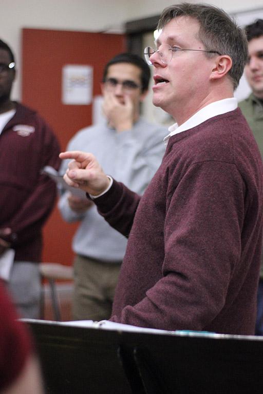 Dale Heidebrecht, assistant music professor, leads the cast of UrineTown through their first rehearsal, Tuesday Dec. 5, 2017. Photo by Rachel Johnson