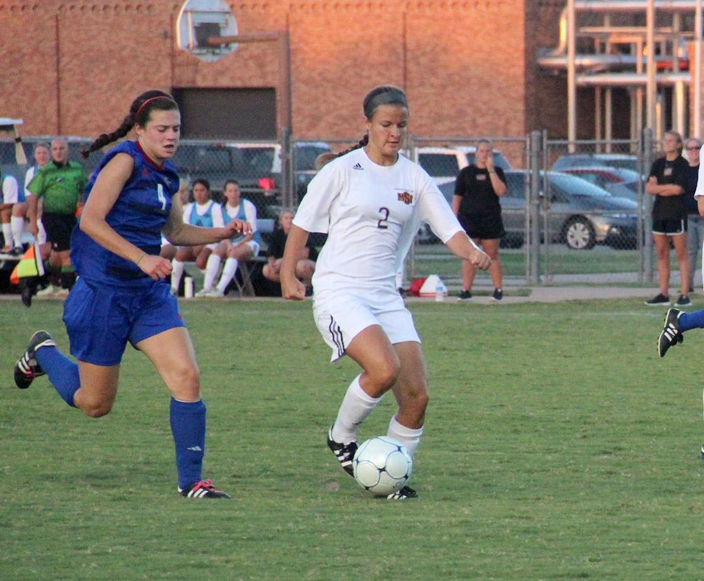 Aly Wade, exercise physiology sophomore, runs with the ball against Lubbock Christian University Sept. 19 at the MSU Soccer Field. MSU won 2-1. Photo by Miguel Jaime