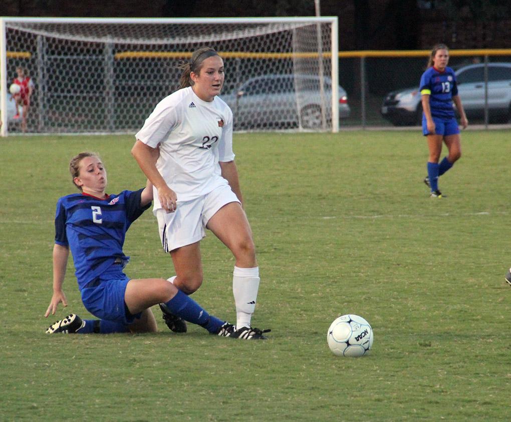 Ashley Cottrell, environmental science junior, is tripped up against Lubbock Christian University Sept. 19 at the MSU Soccer Field. MSU won 2-1. Photo by Miguel Jaime