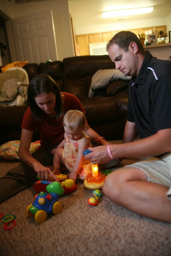 Angie and Christopher Reay playing with their 11-month old daughter Allison Monday afternoon.
Photo by HANNAH HOFMANN