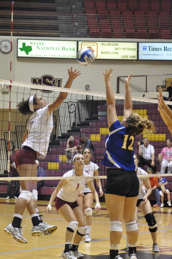 Michelle Blount tips the ball over the net.
Photo by MEGHAN MYRACLE