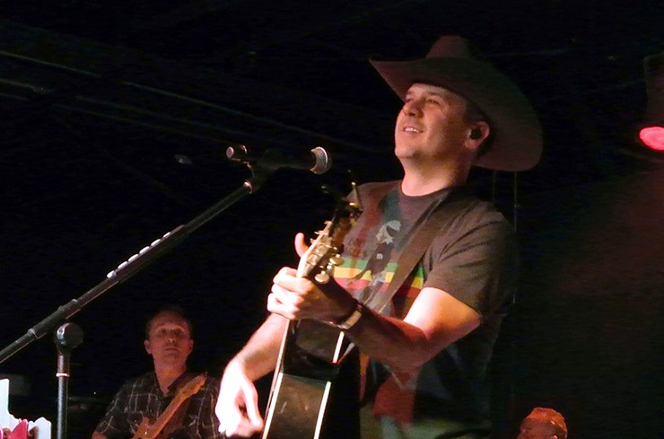 Roger Creager stares intently at the crowd as he opens up his concert with his song Turn it Up from his latest album Surrender at Denim and Diamonds.