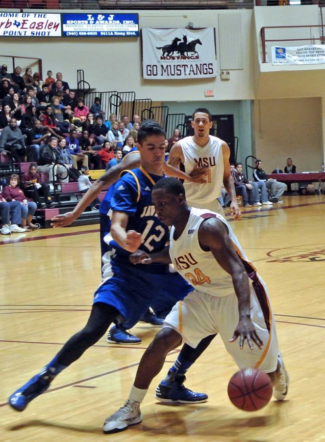 Cam Adderly dribbles past Thomas Diaz. Adderly scored a game high 17 points,  grabbed five rebounds and dished out four assists. 

The men’s basketball program walked out of D.L. Ligon Coliseum with a big 20-point victory over Texas A&M-Kingsville on Feb. 2, outscoring the Javelinas 79-59. 

The Mustangs’ bench provided a huge spark for the team, scoring 36 of the team’s total points. Derek Kaster led all players off the bench with 14 points and eight rebounds. 

The Mustangs extended their Lone Star Conference lead to two games ahead of second place Cameron with the victory. They now stand at 10-2 in the LSC and 14-5 overall. 
Photo by Brianda Morales