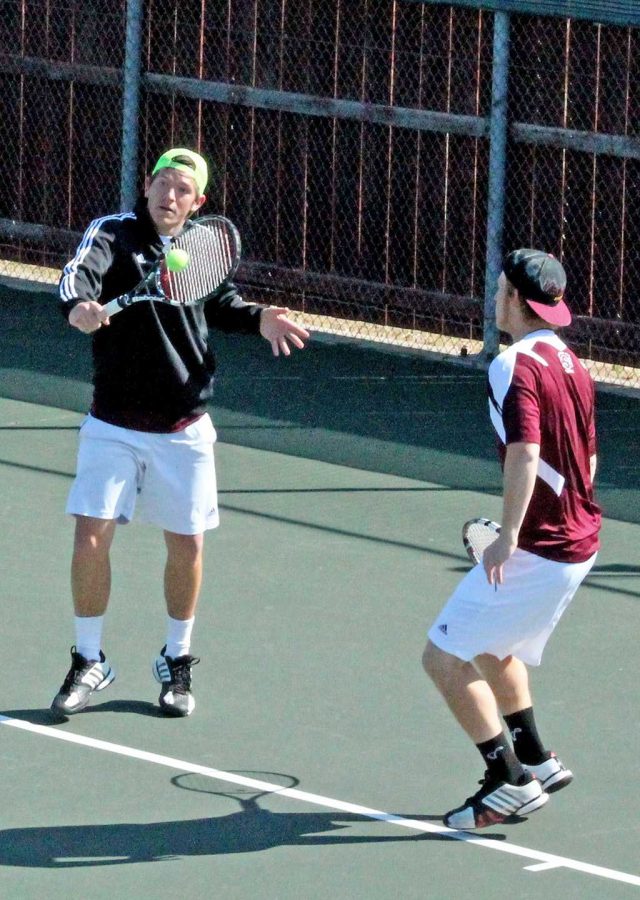 Jarrod Liston, junior, saves a ball while playing doubles with Austin Crawford.