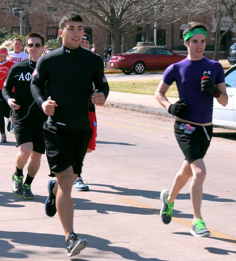 5K winners Taylor Duval, junior in mechanical engineering, Denver Mcclure, sophomore in business, and Peyton White, junior in mass communication, lead the pack early Saturday morning at the Alpha Phi Red High-Heel Walk and 5K.
Photo by Shelby Davis