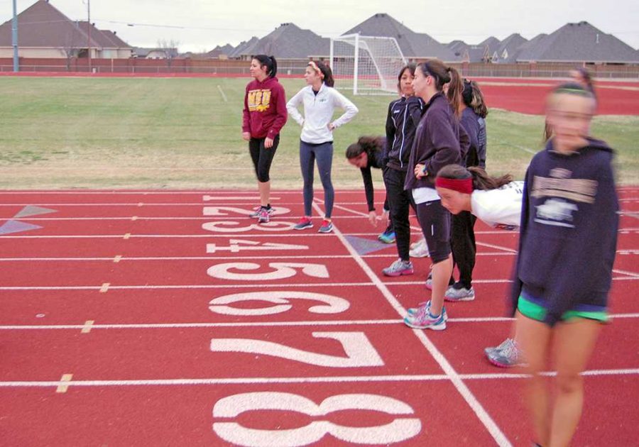 The womens cross country team line up for some post workout tips.
Photo by Caden Burross