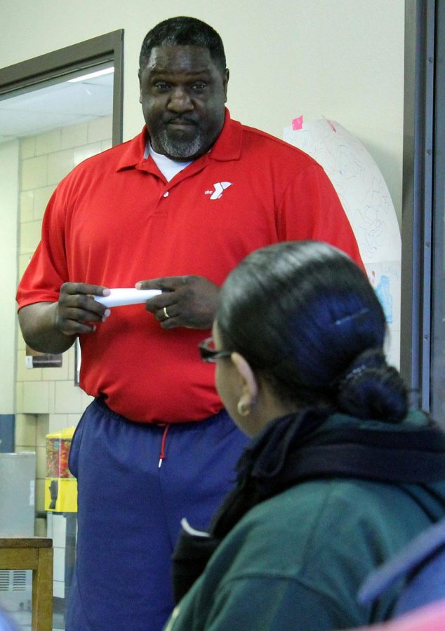 Ronnie Williams, vice-president of operations for the Wichita Falls YMCA, educates students about the history of downtown Wichita Falls on Monday before they begin to volunteer.