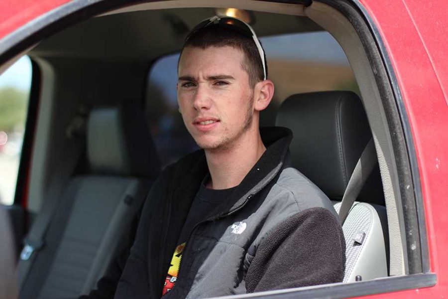 Keith Terrell, Senior in Kinesiology with Teachers Certification sits inside the truck he goes storm chasing in.