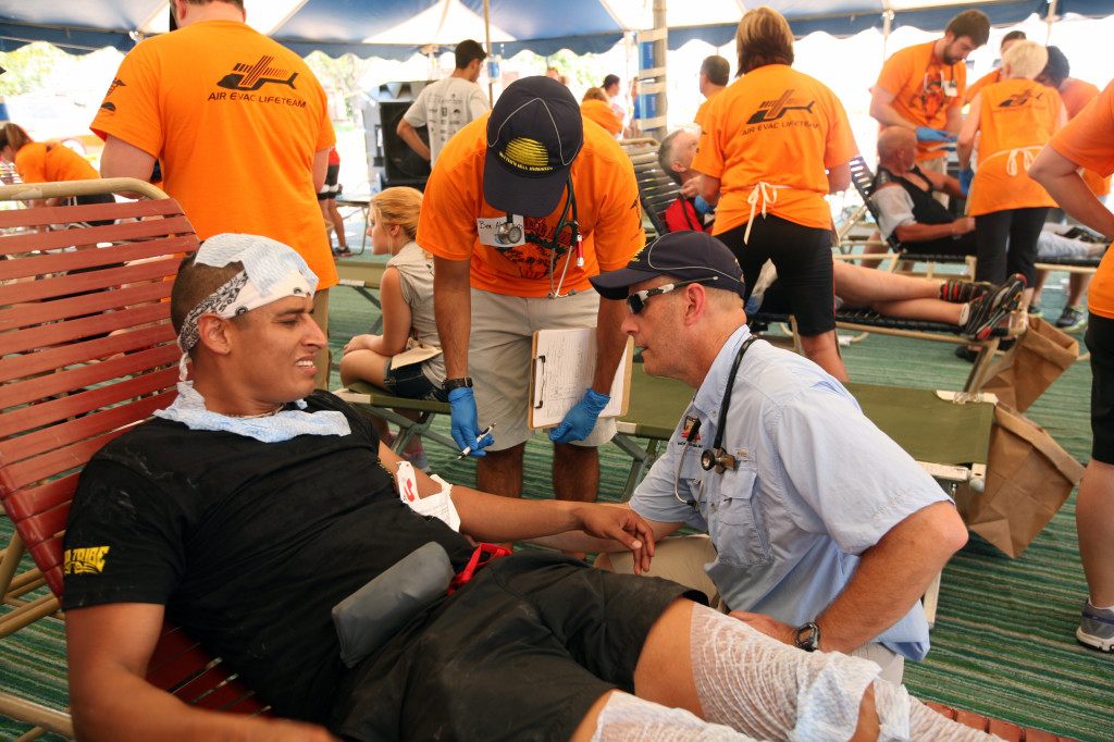Medical director Keith Williamson works with Clayton Carrozza of Lubbock, Texas, in the medical tent at the Hotter 'N Hell 2013 onAug. 24. Carrozza broke his wrist on Loop 11 after he rolled his bike. 