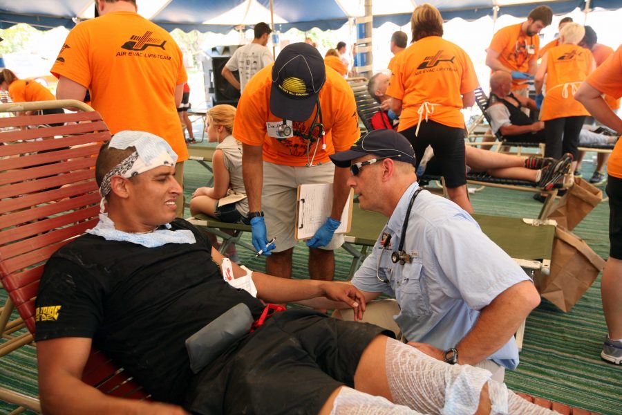 Medical director Keith Williamson works with Clayton Carrozza of Lubbock, Texas, in the medical tent at the Hotter N Hell 2013 onAug. 24. Carrozza broke his wrist on Loop 11 after he rolled his bike. 