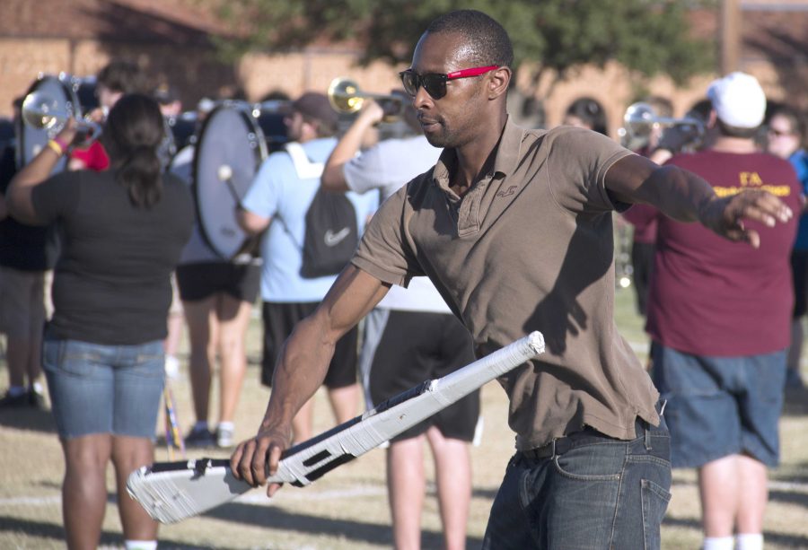 Jammal Cook Reyes, color guard director, goes through the rifle routine during band practice Tuesday, Sept. 3 on the football field.