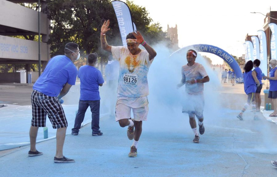 Eric Delacerda, senior in criminal justice, and Dylan Sadata, junior in accounting, pass the blue line and race to the finish line. The distinctive quality of this race is that the runners get doused with color chalk every kilometer, encouraging them to push to the next color.