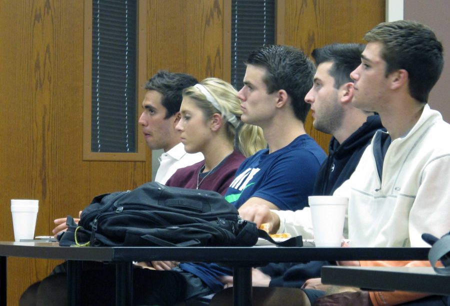 Tony Baca, junior in finance and marketing, Nicole Marzik, sophomore in business administration, David Grates, senior in finance, Garrett Bockman, junior in management, Zach Moore, junior in finance and Alan Reynolds, senior in business, watch Dell Stine talk at the Financial Management Association’s first meeting on Nov. 4 in Dillard College of Business.
