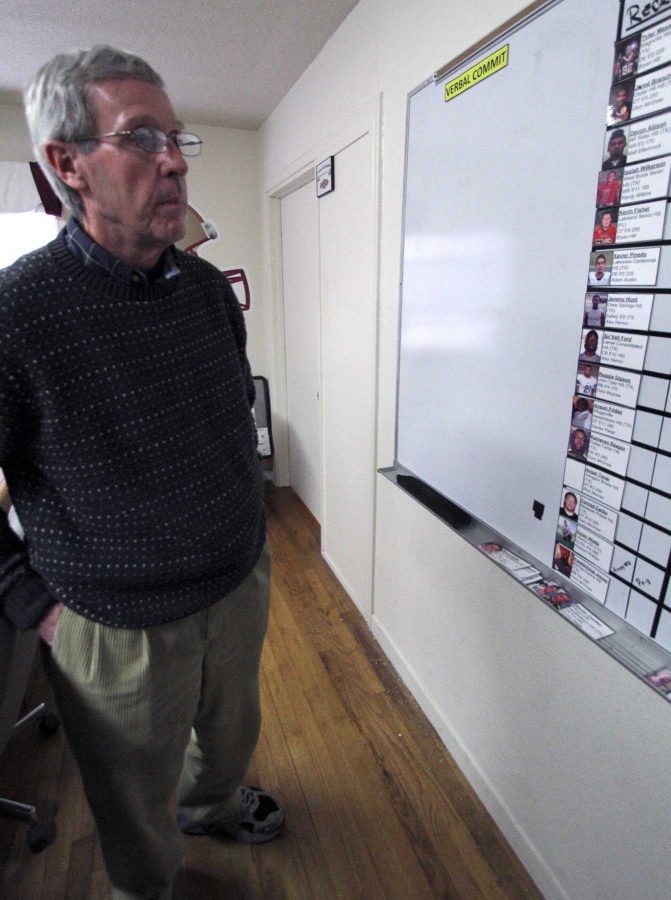 Head Football Coach Bill Maskill looks at the recurit board Tuesday afternoon in the football offices along Hampstead. Photo by Lauren Roberts