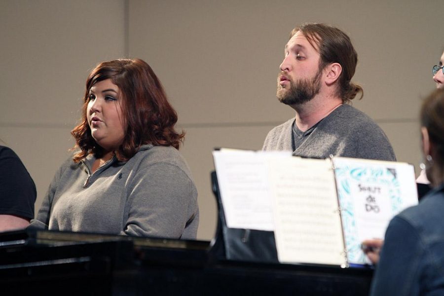 Emily Clements, junior in vocal performance, and Budy Ricardson, junior in percussion performance, sing during the final rehearsal for the spring choral concert Tuesday afternoon in Akin Auditorium. Photo by Lauren Roberts