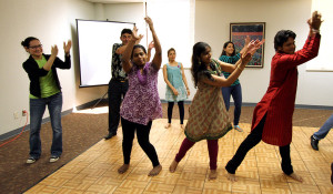 Luzmila Moreno, triple major in criminal justice, political science and spanish, joins members of the Midwestern Indian Students Association for a group dance at the International Fair music breakout session on March 29. Photo by Ethan Metcalf.
