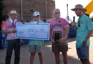 Andy Hollinger, The Racing Post editor, Robert Clark, vice president of administration and institutional effectiveness, Chris Baab, Megan Baab's father, and Charlie Zamastil, director of cycling, present the $10,000 check to Midwestern State University before the start of the Hotter'n Hell women's criterium Friday.