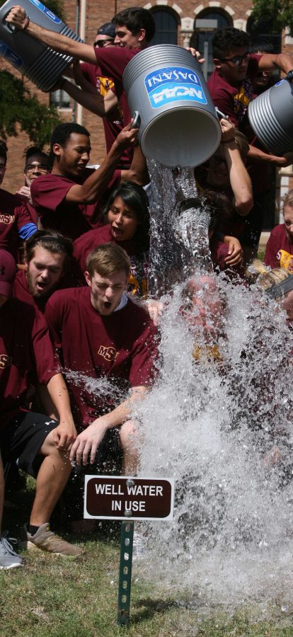 Midwestern State University President Jesse Rogers gets water dumped on him with students as part of an effort to raise money for Amyotrophic lateral sclerosis, commonly called Lou Gehrigs disease. Rogers took the challenge from officials at West Texas A&M and passed the challenge along to Angelo State University. Photo by Bradley Wilson.