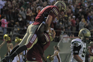 Joel Onyia, nursing sophomore, picks up Jake Glover, accounting senior, after Glover scored a touchdown at the season opener against Missouri University of Science and Technology. Midwestern State University defeated Missouri S&T 40-23 Saturday night at Memorial Stadium. Photo by Lauren Roberts