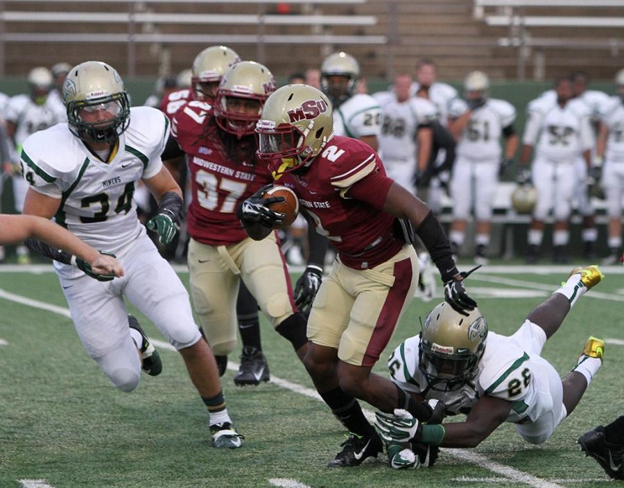 Dominique Williams, criminal justice junior, breaks a tackle during a punt return at the season opener against Missouri University of Science and Technology. Midwestern State University defeated Missouri S&T 40-23 Saturday night at Memorial Stadium. Photo by Lauren Roberts