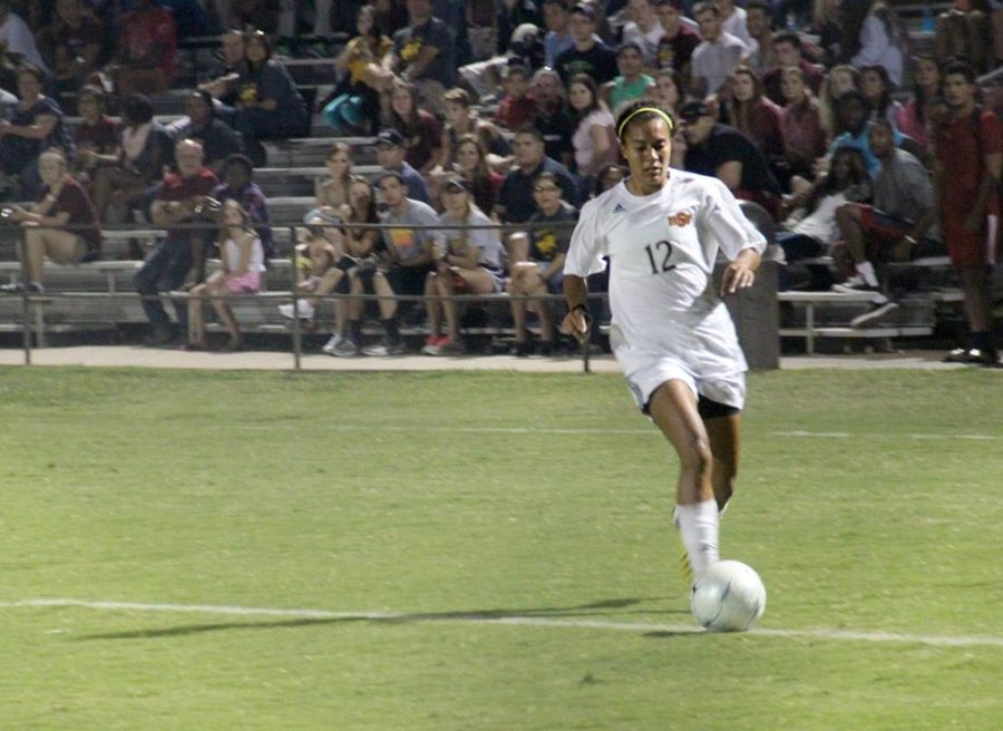Ashley Cottrell, environmental science junior, runs past a defender and the goalie to score Midwestern State Universitys second goal of the night against Southern Nazarene University Tuesday at the MSU Soccer Field. Photo by Lauren Roberts
