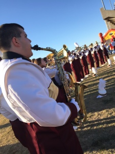 Chris Silva, Music Education Sophomore, warms-up for the Golden Thunder Marching Band's pregame performance.